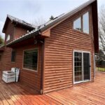 Brown wooden house with sliding glass door